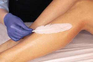 Aesthetic leg waxing process with gentle techniques in a tranquil beauty salon setting photo