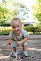 Portait of adorable blonde girl toddler playing and hugging stray kittens photo