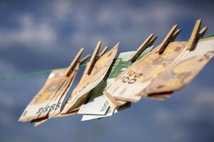 Washed Euro paper bills. Drying euro on a string. photo