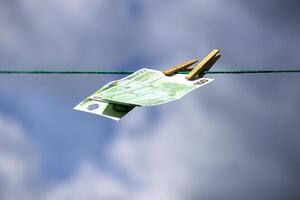 paper money bills flutter in the wind against a blue sky background photo