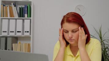 Entrepreneur using laptop writing notes at home office desk tired of working video