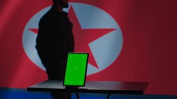North Korean engineer makes troll accounts with mockup tablet on social media promoting communist ideology. Admin works for Pyongyang regime building algorithms to spread government doctrine, camera A photo