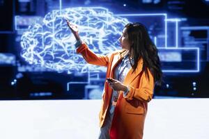 Tech company CEO using summit as platform to launch latest AI services. Manager uses microphone to talk at forum to connect with business leaders and investors interested in artificial intelligence photo