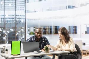 Real estate agent presenting renting opportunity to client next to copy space on tablet, securing a contract with female entrepreneur for business relocation office space. Workspace design. photo