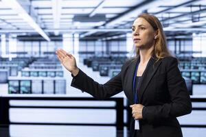 Software developer in data center checking rigs and hardware, doing checkup with AR hologram. Worker planning and executing server hub migrations and upgrades using augmented reality photo