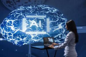 Computer scientist in startup doing advancements in AI field. Woman working on laptop in cutting edge workspace featuring artificial intelligence and neural network systems photo