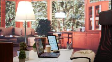 Empty modern home workstation of an entrepreneur with laptop and tablet, financial analytics data studied for startup investment and development. Remote job in business industry. photo