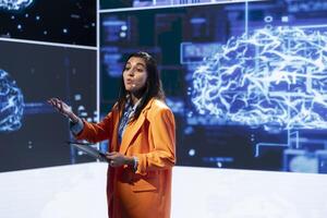 Presenter talking with spectators at AI convention bringing together IT professionals, sharing insights from latest developments in artificial intelligence and cognitive computing photo