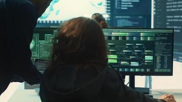 Governmental hackers team working on digital security and cyber defense measures, using pc and big screen. Experts focusing on cyber operations, network security and server protection. Camera A. photo