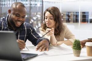 Entrepreneurs collaborating with a contractor agent on office space planning, evaluating blueprints and discussing strategy for leasing a new high class workspace. Modern relocation. photo