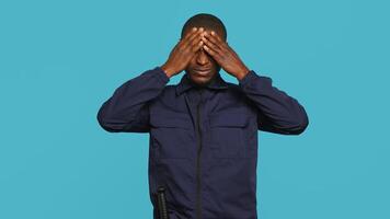 Clueless security guard shrugging shoulders, unable to answer people inquiries. Portrait of bodyguard doing lacking knowledge hand gesture, isolated over studio background, camera A photo