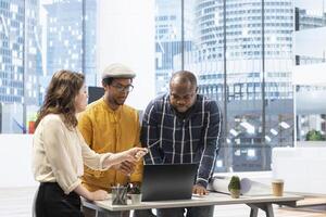 Clients and their real estate agent strategize office space planning, using blueprints to discuss investment opportunity and the layout of an urban workspace. Strategy for workspace relocation. photo