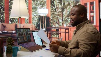 Businessman reviewing the financial reports with the shareholders on a videocall meeting at home. Specialists analyzing expansion plans to provide new business funds. Startup growth. Camera B. photo