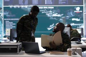 Military experts in an operations center handle satellite data details, overseeing live surveillance for reconnaissance activity. Intelligence operations to support strategic military missions. photo