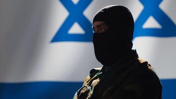Mossad intelligence corps agent standing proud in front of Israel flag, feeling pride in serving country. Close up shot of Israeli counterintelligence operation spy in war room crossing arms, camera A photo