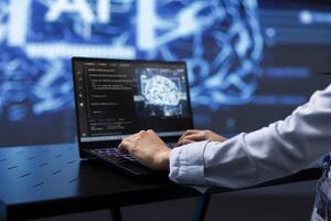 Software developer uses AI cognitive computing to extract information from complex data on laptop. Close up of worker using artificial intelligence on notebook to accelerate complex calculations photo