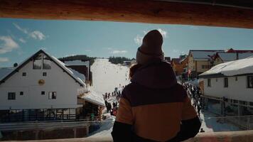View from the hotel balcony to the snowing ski path resort. video