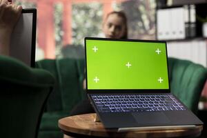 Therapist uses green screen display in a counseling session with an adolescent dealing with low confidence. Psychotherapist supports her in building resilience and self esteem. photo