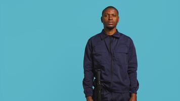 Security guard tasked with preventing criminal activity and detaining suspects stealing, damaging property, or performing other crimes. Portrait of intimidating bodyguard, studio background, camera B photo