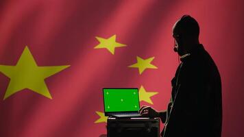 Chinese air defense using radar system on green screen laptop to detect intercontinental ballistic missiles. Republic of China army soldier scanning rockets with mockup notebook, camera B photo