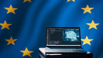 AI software on laptop used by European Union member states security services to prevent terrorism. Artificial intelligence tech used by Europe countries to defend, isolated over EU flag, camera B photo