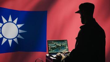 Communication systems operator working for Taiwanese freedom fighters uses radio and satellite equipment. Taiwan army unit manages broadcasting networks during territorial dispute with China, camera B photo