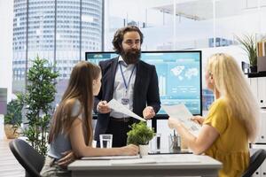 Parent and teenager in office doing brainstorming after listening investment strategy recommendations from financial advisor. Customers consulting after taking economic guidance from consultant photo