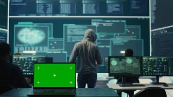 Isolated copy space running on a laptop in high tech agency office, governmental hackers analyzing digital threats on big screens. Working on cybercrime and protection against phishing. Camera B. photo