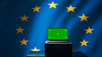 EU alliance engineer uses green screen laptop to protect against fake accounts on social media. Technician doing cybersecurity job for European Union with mockup notebook, camera B photo