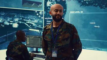 Lieutenant general coordinating his army troops for a complex military operations, ensuring every unit is synchronized and informed about a new national safety mission. Command center. Camera B. photo