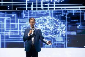 Happy presenter speaking at tech forum, explaining impact of artificial intelligence technology. Smiling expert presenting risks and threats associated with AI during networking workshop photo