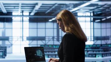 Computer scientist in data center using artificial intelligence computing simulating human brain. IT professional working on notebook with AI machine learning algorithms, camera A photo