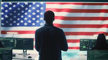 A technical team in a governmental cyber environment with the USA flag. Focus on cybersecurity strategy, threat management and secure operations for national security and digital defense. Camera B. photo
