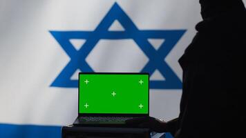 Israel air defense command operator conscript using radar on green screen laptop to detect incoming missiles. IDF army soldier scanning rockets and deploying shields with mockup notebook, camera A photo