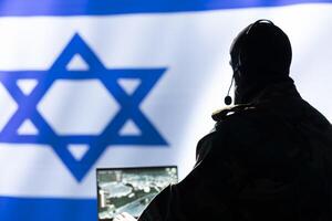 Iranian spy in control room uses military tech to identify threats during Arab Israeli conflict. Mossad intelligence agent uses software to relay info to generals on war front line photo