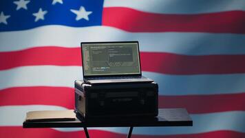 Laptop in CIA command center used by counterterrorism agents to run surveillance efforts against enemy of United States in conformity with Patriot Act law, isolated over USA flag, camera A photo