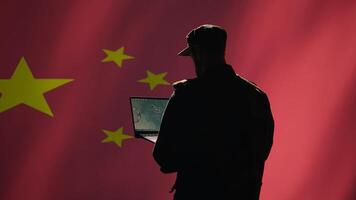 Chinese soldier using radar detecting ballistic missile attacks and conducting general space surveillance and satellite tracking. CCP agent using military laptop software preventing rockets, camera B photo