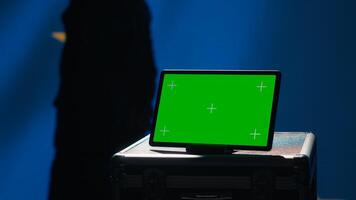 European Union agency operator using military tech on green screen tablet to identify threats from enemies. EU treaty security personnel using mockup device to relay info to war front lines, camera A photo