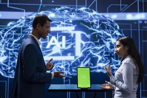 Engineers in high tech facility use AI machine learning on mockup tablet. Experts in modern workplace use artificial intelligence technology on chroma key device, doing brainstorming photo