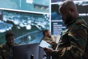 Government intelligence officers in a control center managing surveillance activity, analyze real time data and coordinate security measures. Soldiers ensuring national interests and efficiency. photo