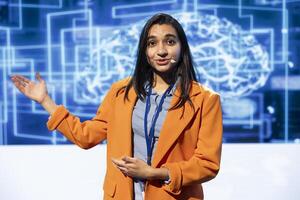 Portrait of engaging presenter talking at AI convention using mic, sharing industry expertise to inspire audience. Engineer exploring latest artificial intelligence products and tools at tech event photo