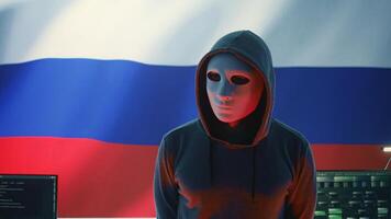 Russian hacker in a governmental IT environment with a russian flag on big screen, dealing with cyber terror, ransomware and espionage. Installing misinformation and aggression propaganda. Camera B. photo
