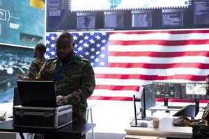 Military professionals in a command center monitor global cybersecurity operations, managing surveillance data and protect national security using advanced technology and teamwork. photo