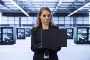 Technician in data center implementing backup solutions to protect against data loss using notebook, ensuring efficient recovery processes. Server hub worker identifying and resolving technical issues photo