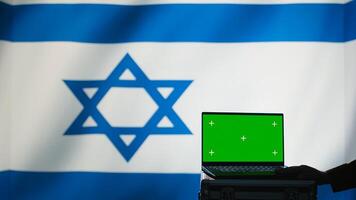 Israel air defense command operator conscript using radar on green screen laptop to detect incoming missiles. IDF army soldier scanning rockets and deploying shields with mockup notebook, camera B photo