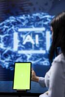 Admin running AI cognitive computing tech on mockup tablet to simulate computerized model. Close up of green screen device used by IT specialist to do data mining with artificial intelligence photo