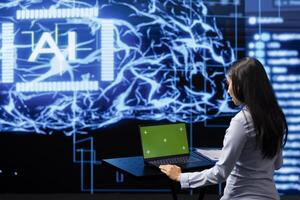 IT expert using green screen laptop and AI technology for business data analysis in high tech setting. Admin works on mockup notebook to automatize tasks using artificial intelligence photo