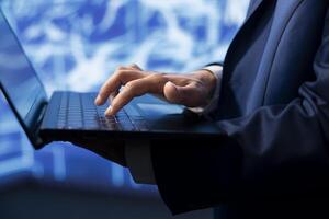 Data analyst using laptop to implement artificial intelligence parallel processing, breaking up complex computational tasks enabling AI systems to process more input data faster, close up shot photo