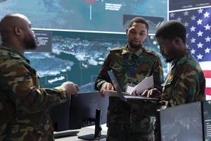 US soldiers in a cyber control center engaging in cybersecurity operations, handling classified information and ensuring the security of state secrets and government data. Surveillance footage. photo