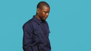Cheerful security guard celebrating achievements during protection job shift. Portrait of joyous bodyguard feeling satisfied after completing tasked orders, studio background, camera A photo